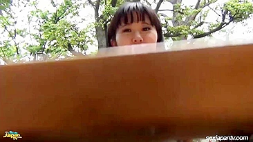 Amateur flashing of Japanese female pulling white panties aside and showing hairy snatch off in street