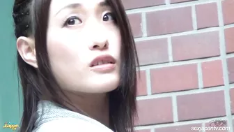 Japanese chick pushes panties aside and spreads butt to show pussy in street