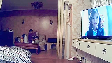 Young Chinese couple set cheap amateur camera to film their fucking by TV