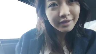 Asian girl with round tits is masturbating in car while friend with camera is filming her