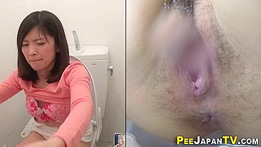 Hidden camera films Japanese woman masturbating pussy in restroom