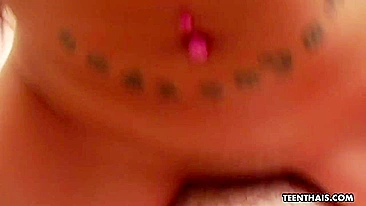 Shaved pussy of Thai teen with tattooed back slides on cock