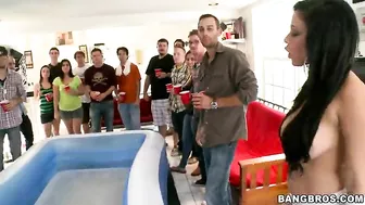 Guys watch colleagues posing and shaking shapes in the pool