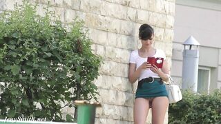 Brave brunette Jeny Smith walks around streets dressed in short skirt that exposes her trimmed cunny