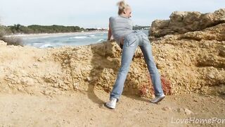 Photographer owns blonde with skinny body on stony beach