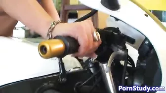 Naked girl with black hair and mechanics fool around in garage