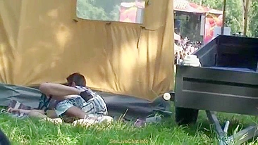 Guy owns girlfriend behind tent and cums on ass in voyeur video