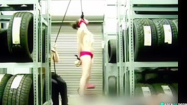 Naked girl suspended by the neck in her boyfriend's garage