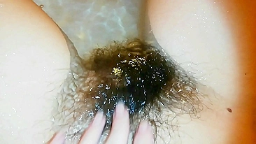 Narcissistic girl likes nothing more than playing with a hairy bush