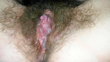 Close-up video of the girl masturbating hairy cunt with a vibrator