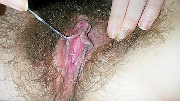 Close-up video of the girl masturbating hairy cunt with a vibrator