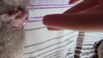 Horny wench pulls panties aside to play with big clit on the bed