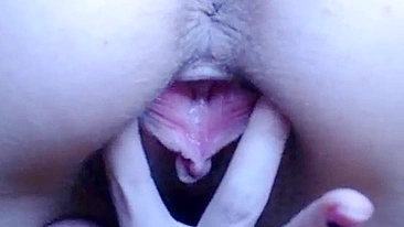 Possessor of a big clit plays with it in front of the camera