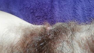 Naughty mom captures on camera how she is fingering own hairy bush