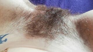 Naughty mom captures on camera how she is fingering own hairy bush