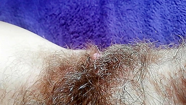 Naughty mom captures on camera how she is fingering own hairy bush