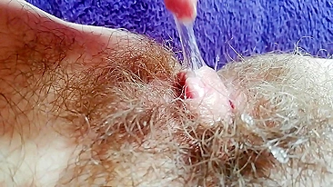 Naughty mom captures on camera how she is fingering own hairy bush