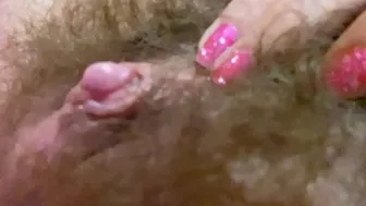 Belle with hairy bush touches big clit till achieving squirt orgasm