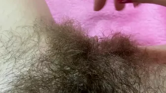 Belle with hairy bush touches big clit till achieving squirt orgasm