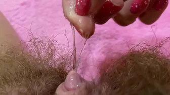 Belle with hairy bush touches big clit till achieving squirt orgasm