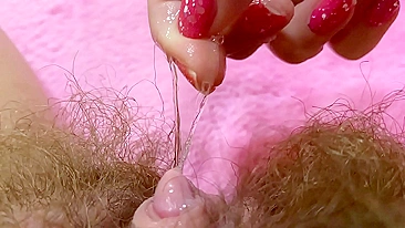 Belle with hairy bush touches big clit till achieving squirt orgasm