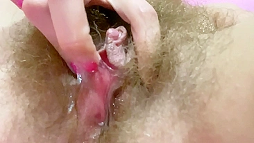 Belle with hairy bush touches big clit till achieving squirt orgasm