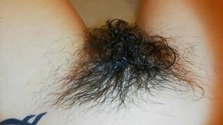 Amateur mom with super hairy bush relaxes naked in the bathroom