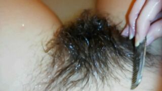 Amateur mom with super hairy bush relaxes naked in the bathroom