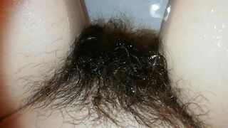 Amateur mom with super hairy bush relaxes naked in the bathroom