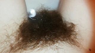 Amateur mom with super hairy bush relaxes naked in the bathroom