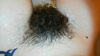 Amateur mom with super hairy bush relaxes naked in the bathroom