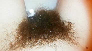 Amateur mom with super hairy bush relaxes naked in the bathroom