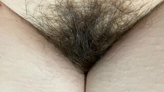 Mom demonstrates her hairy cunt with huge bush in extreme close up video