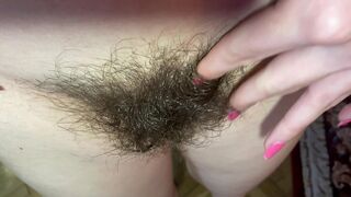 Mom demonstrates her hairy cunt with huge bush in extreme close up video