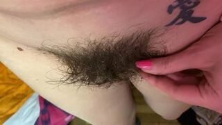 Mom demonstrates her hairy cunt with huge bush in extreme close up video