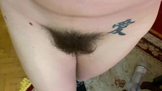 Mom demonstrates her hairy cunt with huge bush in extreme close up video