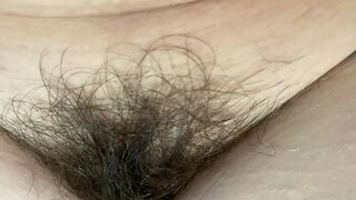 Mom demonstrates her hairy cunt with huge bush in extreme close up video