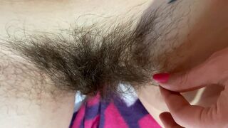 Mom demonstrates her hairy cunt with huge bush in extreme close up video