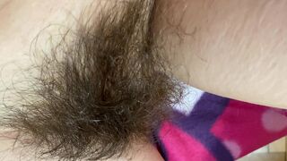 Mom demonstrates her hairy cunt with huge bush in extreme close up video