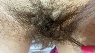 Mom demonstrates her hairy cunt with huge bush in extreme close up video