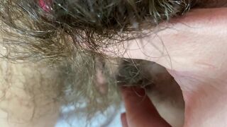 Mom demonstrates her hairy cunt with huge bush in extreme close up video