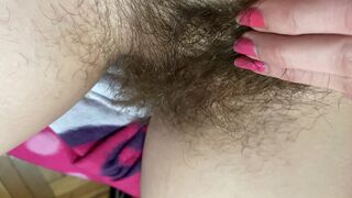 Mom demonstrates her hairy cunt with huge bush in extreme close up video