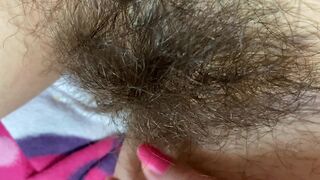 Mom demonstrates her hairy cunt with huge bush in extreme close up video