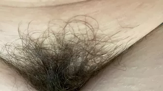 Mom demonstrates her hairy cunt with huge bush in extreme close up video