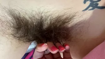 Mom demonstrates her hairy cunt with huge bush in extreme close up video