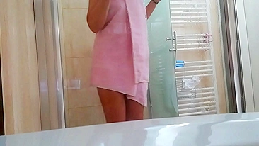 Slim girl washes her hairy bush while taking hot shower in the hotel