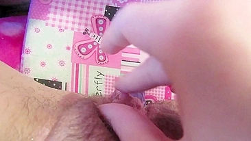 Girl rubs her big clit and uses dildo for hairy twat in amateur clip