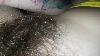 Panties can't hide hairy bush which the babe caresses till orgasm