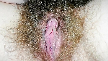 Panties can't hide hairy bush which the babe caresses till orgasm