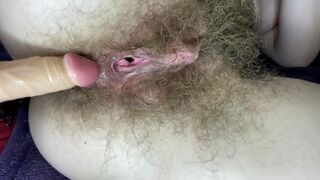 Blonde whore sticks dildo into her impossibly-hairy cunt till orgasm